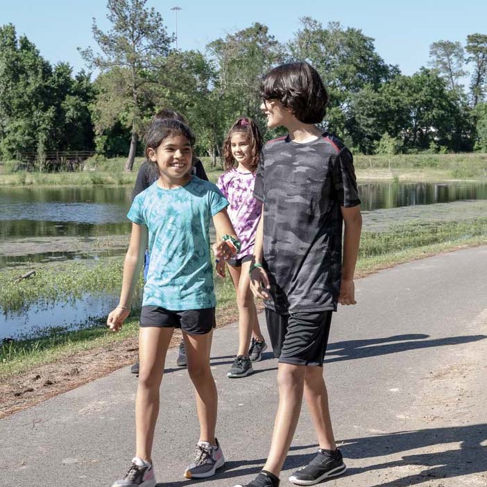 A group of south Asian pre-teens taking a walk along a nature path