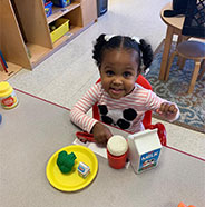 Toddler playing with toy food