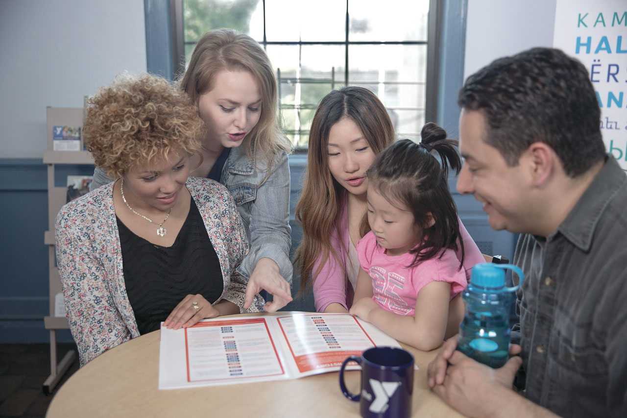 4 adults and 1 child at meeting table